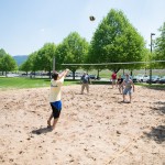 Friendly competitions include volleyball in a summery sand pit ...