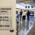 Potential bidders survey the auction floor at Madigan Library