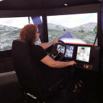 Pamela Mix, secretary to the ESC executive director and assistant dean of transportation and natural resources technologies, takes the wheel of the simulator.