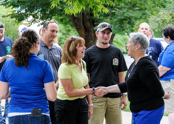 President Davie Jane Gilmour welcomes a family to campus during Saturday's
