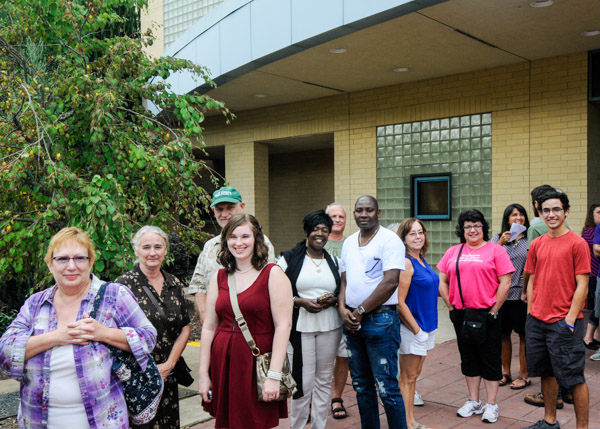 Weekend guests gather outide the Bush Campus Center for a trolley trip through the college's historic neighborhood.