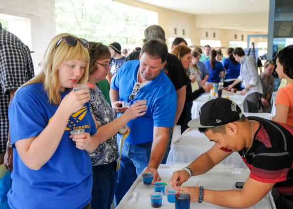 Pouring samples of his