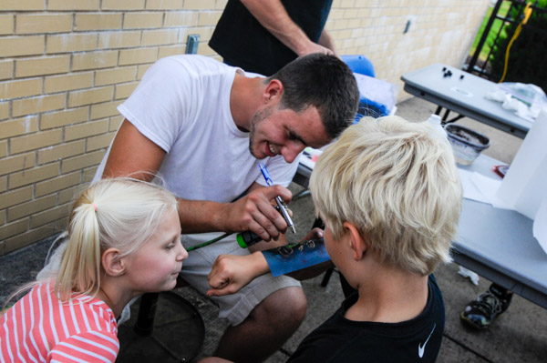 Fun and games include temporary body art.