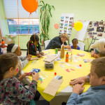 Applied human services seniors Stacey L. French (center background) and Tima Cummings (foreground) assist with creative and crafty endeavors.