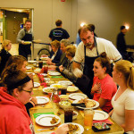 Thanksgiving dinner with all the trimmings is served by Brian J. Schurr (background), counselor, and David Kay, vice president for college services.