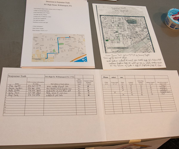 Signup sheets and maps point volunteers in the direction of their afternoon destinations.