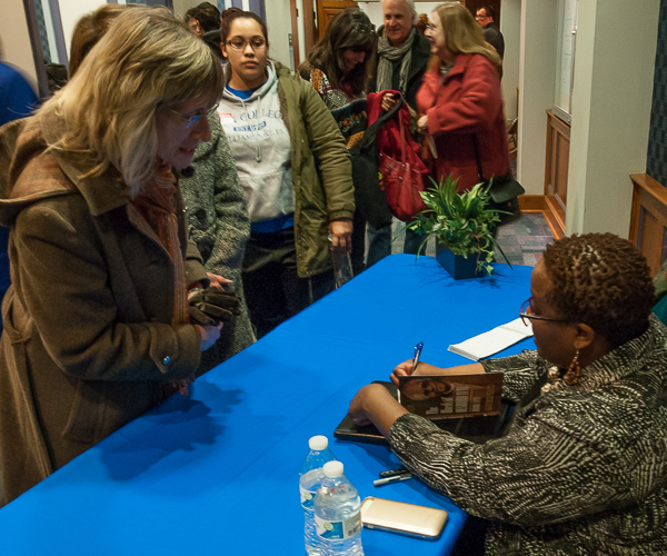 Tutu signs a copy of her book,