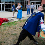 A fencer's friendly face betrays the seriousness at swords' point.