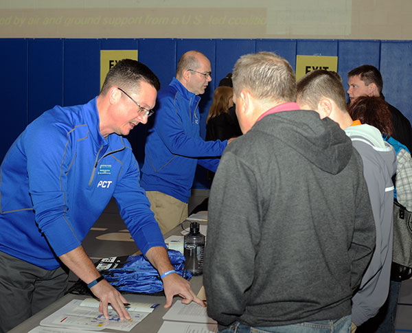 Open House guests are checked in by Walter J. Shultz (foreground), director of the Office of Instructional Technology, and Daniel F. Warner, web programmer/analyst.