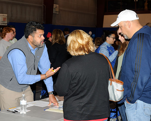 With highlighter in hand, Paul R. Watson, dean of academic services and college transitions, helps a family map out an itinerary.