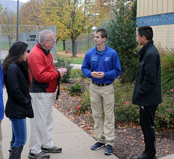 Bryan M. Behm, one of the college's knowledgeable and ever-helpful student ambassadors, greets Open House visitors arriving at the Field House for check-in.