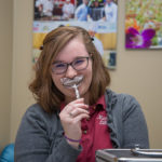 Autumn M. Devine, president of SMAC, adds a little levity to her sales duties. Devine is an emergency management technology student from Mars.