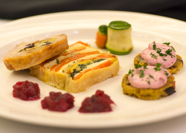 ... an offering of turkey roulade stuffed with roasted cranberry cornbread; roasted vegetable and ricotta cheese terrine; vegetable flowers; and cornbread stuffing crostini with cranberry goat cheese spread.