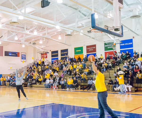 Nursing student Taylor D. Brooks (left), of Cogan Station, celebrates winning a tablet during