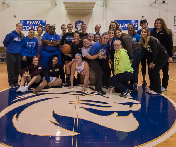 Current and former players assemble at midcourt.