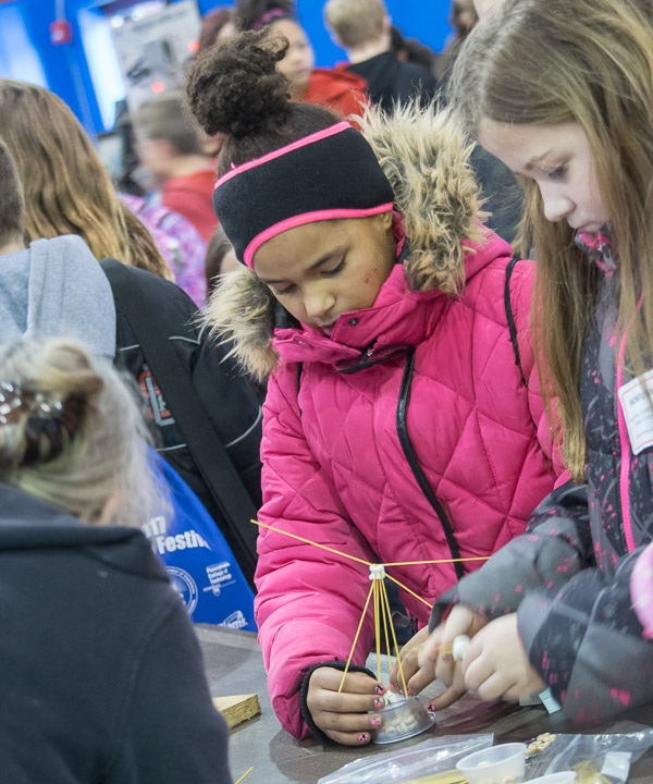 An Odyssey of the Mind booth poses an interactive tower-construction challenge.
