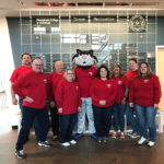 The Penn College Wildcat, joined by financial aid personnel on Monday, prepares to canvass campus offices for spare-change scholarship donations. Accompanying the mascot, from left, are Michael D. Seitzer, a Veterans Affairs work-study student; Chet Beaver, financial aid specialist, veterans services; Dennis L. Correll, associate dean for enrollment management; Kara L. Daneker, financial aid specialist, needs analysis; Kimberly A. Venti, financial aid specialist, support services; Gale I. Grove, financial aid assistant; Jessica S. Hunter, assistant director of financial aid; and Jen M. Baker, financial aid specialist, federal programs.