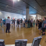 Guests listen to a brief introduction by Thomas C. Heffner, assistant dean of sciences, humanities and visual communications.
