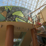 Stabley works on taping prior to grouting the piece.