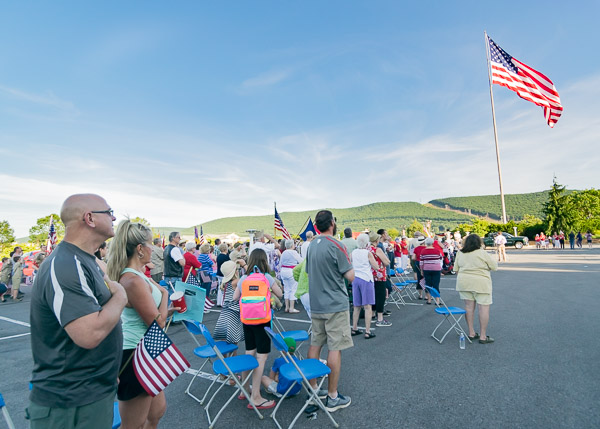 Attendees stand together as part of a nationwide pledge.