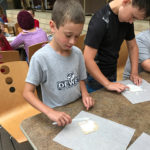 "Concentration" is the mantra for these campers, spreading the groundwork in their makeshift kitchen.