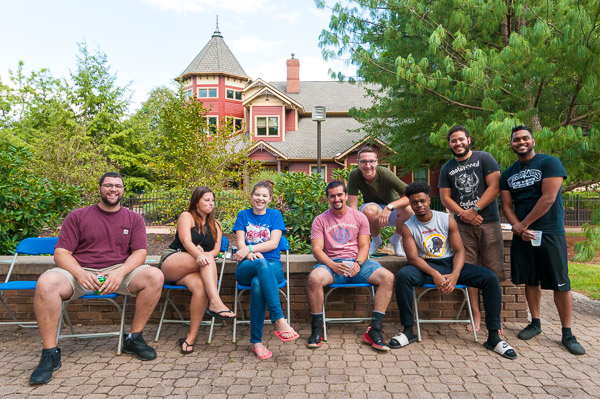 The Victorian House environs provide attractive greenery and scenery that can only be enhanced by the fun-loving students gathered for the Second Saturday Jamboree.
