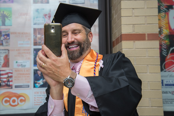 Enjoying a lighthearted moment with a college photographer is physician assistant graduate Eric M. Danz, of Hershey.