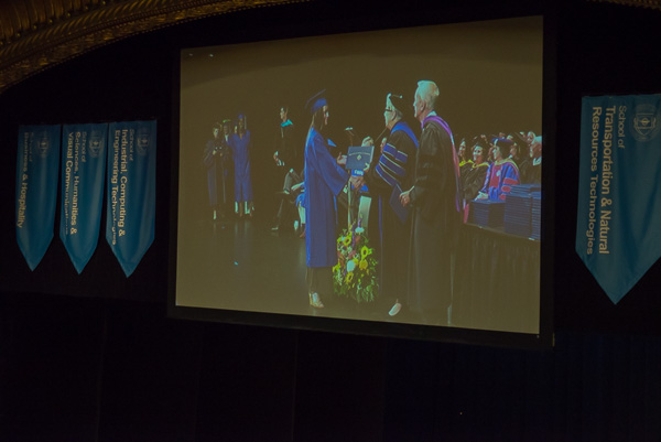 A large screen above the stage gives audience members a closer view of the big moment.