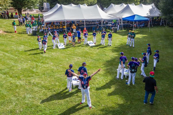 While his teammates toss beanbags instead of baseballs, a player looks to an eye in the sky.