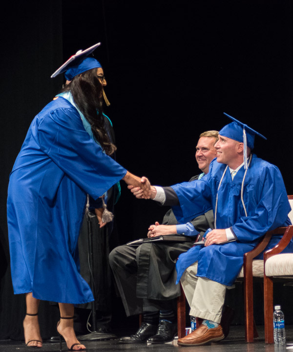 Congratulating the student speaker en route to her own spotlight moment