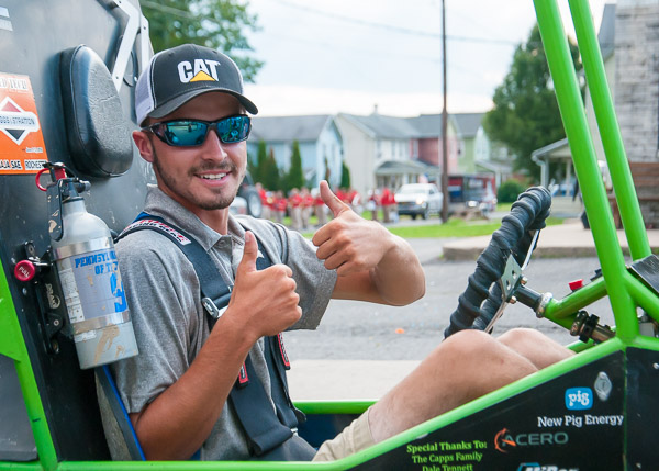 Manufacturing engineering technology student Trevor M. Clouser, behind the wheel of one of two Baja vehicles at the event
