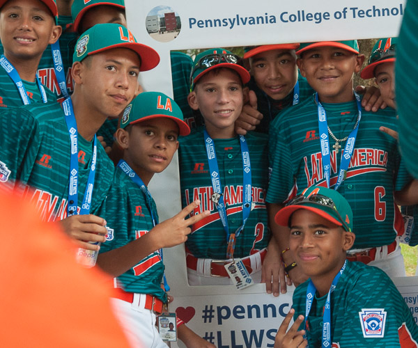 Players pose in and around a Penn College frame.
