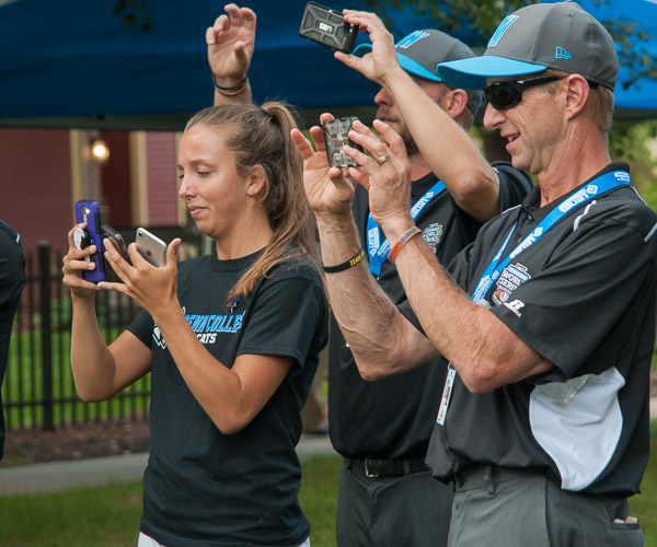 Bystanders juggle smartphones to capture once-in-a-lifetime photos for the teams.
