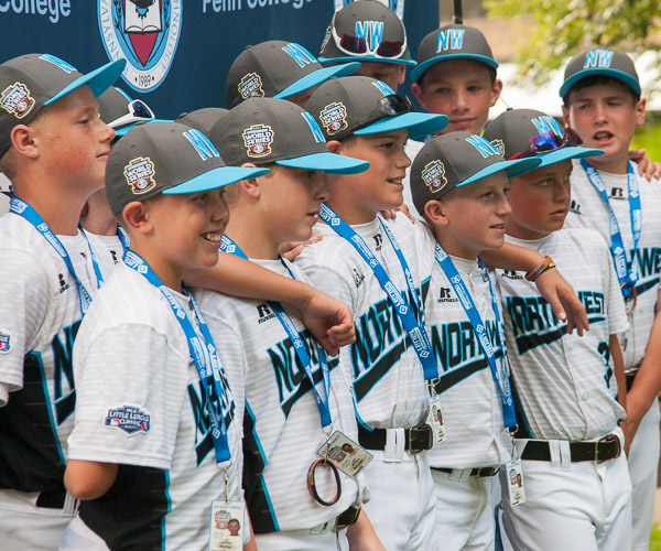 Players from Walla Walla, Wash., representing the Northwest region, gather for a photo in front of the college’s “step and repeat” banner.