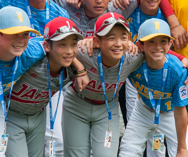 Players from the Japan and West teams, who shared a bus on the way to the picnic, go halves on a photo opportunity.