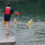 A paramedic student perfects her pitch, throwing a line to a waiting classmate.