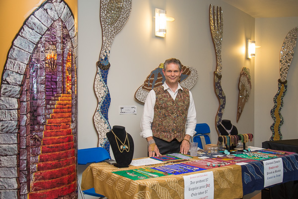 Joseph E. LeBlanc, assistant professor of physics, sells his chain-mail wares – appropriate décor for ravishing Renaissance regalia.