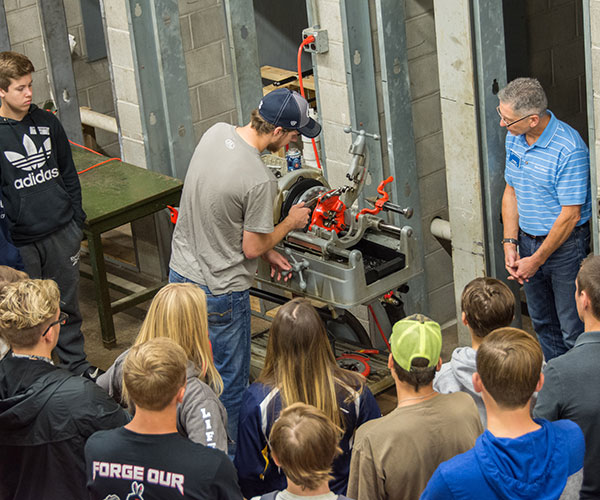 Kenneth E. Welker Jr., instructor of HVAC technology, enlists the help of Ryan P. Kerstetter, a heating, ventilation & air conditioning design technology student from Richfield, in demonstrating pipe-threading while leading a session in “Toiletology-Call the Plumber: Everybody goes, but how much do you know?”