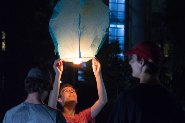 Steadying his lantern for takeoff, a student adds to the collective hope for a cure.