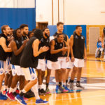 The men's team gathers at midcourt for introductions.