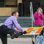 Bradley M. Webb, assistant dean of industrial, computing and engineering technologies, gives it everything he's got – while colleague Stacey C. Hampton makes sure not to miss one second of the fun.