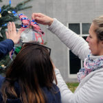 Regina M. Peluzzo (left), of Philadelphia, a civil engineering technology major, and Jennifer L. Nicholson, an applied health studies: radiography concentration major from Lock Haven, find just the right spot for a special ornament.