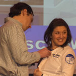 Francesca B. Monse, of Selinsgrove, looks back toward her family while her husband attaches her pin.