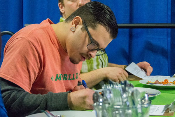 Alumnus/judge McGlynn marks his score sheet.
