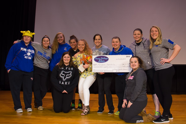 The winner is surrounded by friends and fans, including some of her teammates on the Wildcat softball team.