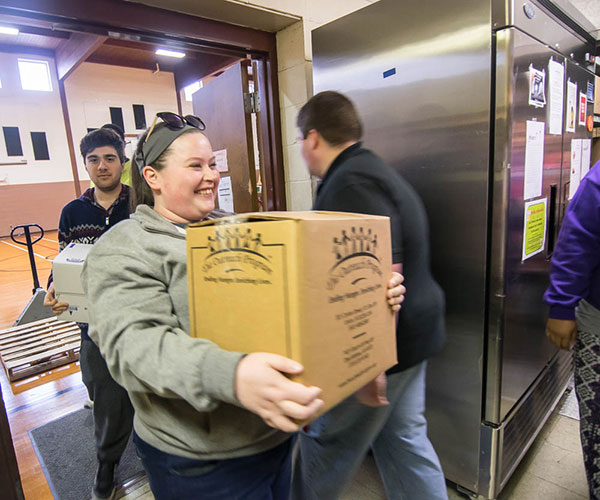 Volunteers help sort and shelve at the Salvation Army Food Pantry ...
