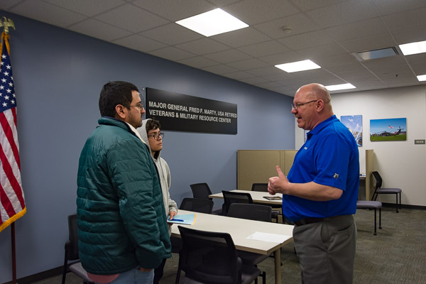 Chet Beaver (right), coordinator of veteran and military services, offers information about the Veterans Center and campus benefits, opportunities and resources.
