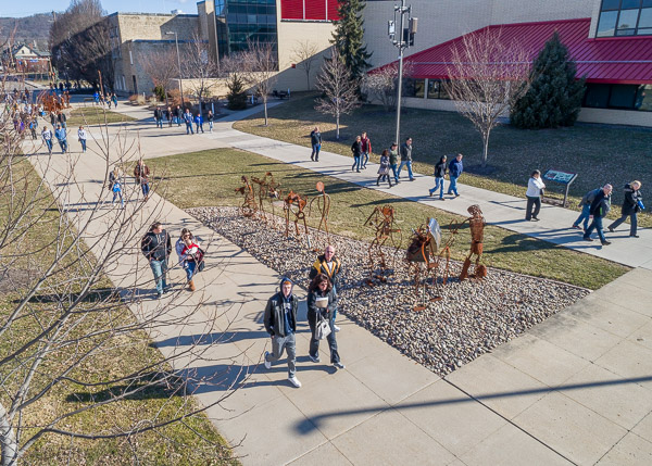 Prospective students and other guests progress past the “Student Bodies” sculptures.
