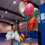 Pride flags and balloons suitably add color to the festivities.