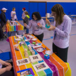 Participants take brushes in hand for a painting activity hosted by PC Alliance.
